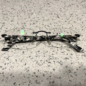 Airlock Rimless Frames in Black/White w/ Black Metal Front. B & W Plastic Temple